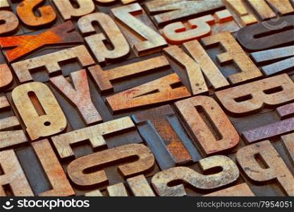 alphabet abstract in vintage letterpress wood type printing blocks stained by color inks