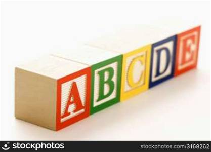 Alphabet blocks lined up in a row.