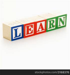 Alphabet building blocks spelling the word learn.