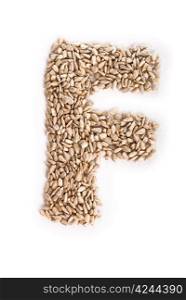 Alphabet F made of sunflower seeds.