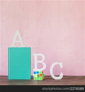 alphabet letters with book rubiks cube table
