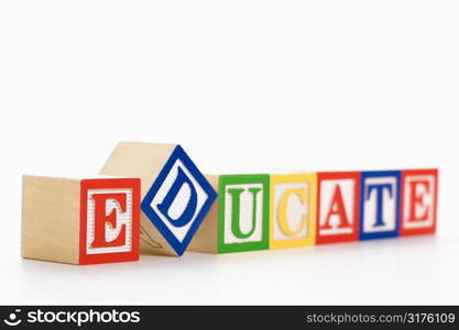 Alphabet toy building blocks spelling the word educate.