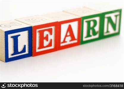 Alphabet toy building blocks spelling the word learn.