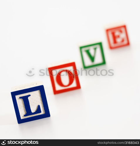 Alphabet toy building blocks spelling the word love.