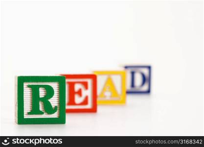 Alphabet toy building blocks spelling the word read.