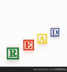 Alphabet toy building blocks spelling the word read.