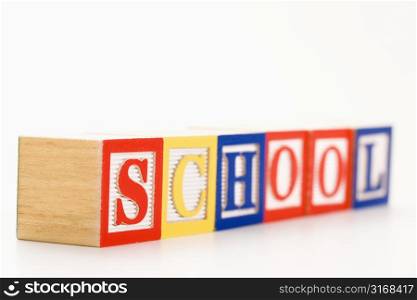 Alphabet toy building blocks spelling the word school.