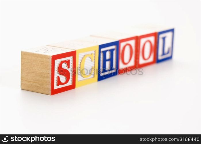 Alphabet toy building blocks spelling the word school.