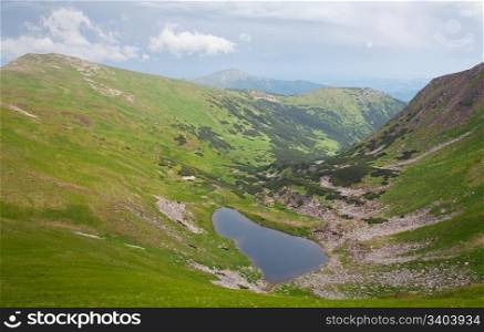 Alpine lake Brebeneckul on summer mountain ravine (Ukraine, Chornogora Ridge, Carpathian Mountains)