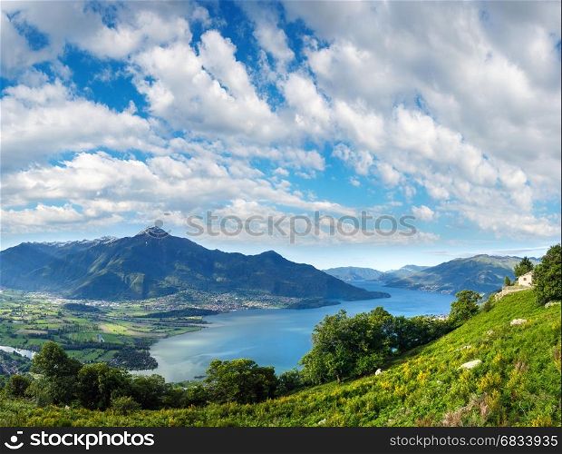Alpine Lake Como summer view from mountain top (Italy) with deep blue cloudy sky.