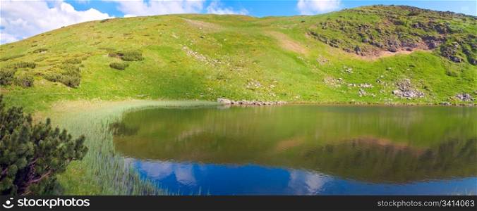 Alpine lake Nesamovyte on summer mountain ravine (Ukraine, Chornogora Ridge, Carpathian Mountains). Three shots stitch image.