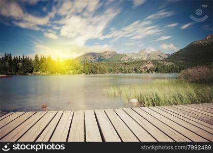 Alpine mountain lake at sunny day