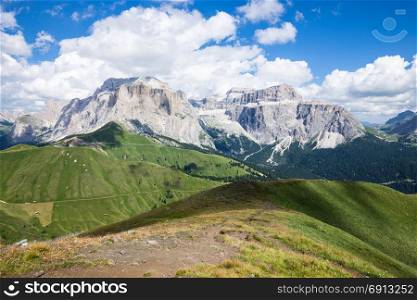 Alpine summer mountain valley. Hugh mountain green grass meadow