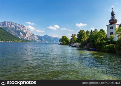 Alpine Traunsee lake summer view with medieval Ort Landschloss tower on right  Gmunden, Austria .