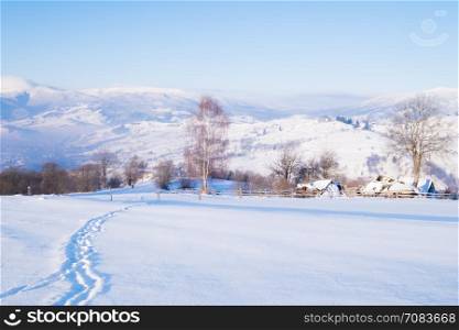 Alpine village at winter mountain hills