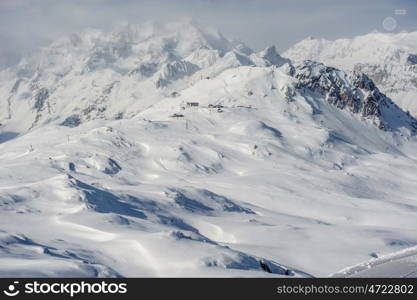 Alpine winter mountain landscape. French Alps covered with snow in sunny day. Val-d'Isere, France