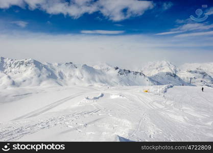 Alpine winter mountain landscape. French Alps covered with snow in sunny day. Val-d'Isere, France