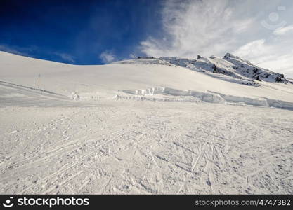 Alpine winter mountain landscape. French Alps covered with snow in sunny day. Val-d&rsquo;Isere, France