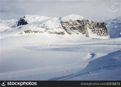 Alpine winter mountain landscape. French Alps covered with snow in sunny day. Val-d&rsquo;Isere, France