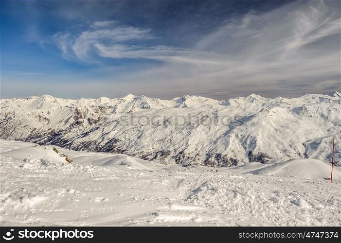Alpine winter mountain landscape. French Alps covered with snow in sunny day. Meribel, France.