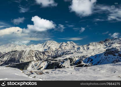 Alpine winter mountain landscape. French Alps covered with snow in sunny day. Meribel, France.