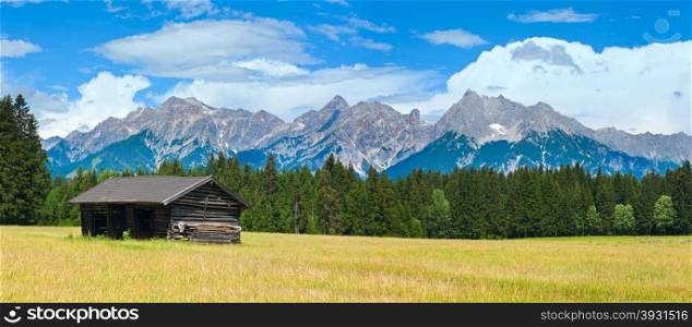 Alps mountain meadow tranquil summer panorama with wooden shed (Austria, Gosau village outskirts)