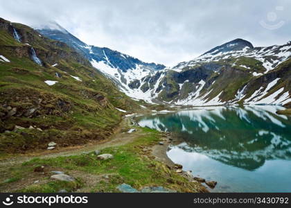 Alps mountains tranquil summer view (reflections on the lake near Grossglockner High Alpine Road)