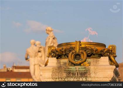 Altar with burning Fire in front of old ancient Building in Rome City, Italy
