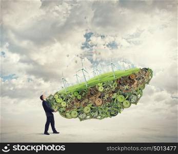 Alternative energy concept. Businessman carrying in hands eco energy module