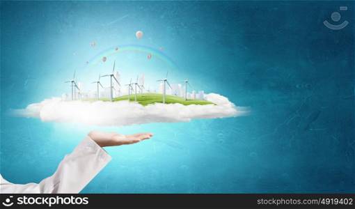 Alternative energy concept. Hands holding eco concept with windmill generators