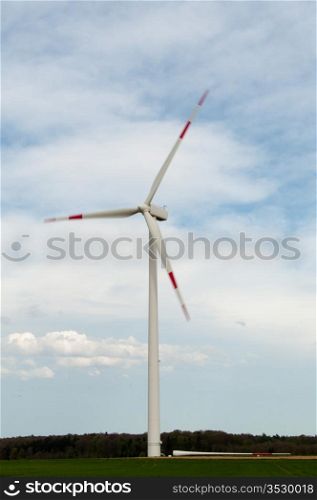 alternative energy source. wind turbine with spare rotor blade lying in front