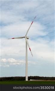 alternative energy source. wind turbine with spare rotor blade lying in front