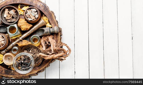 Alternative medicine concept on white wooden background.Herbal medicine or homeopathy. Natural herbs medicine