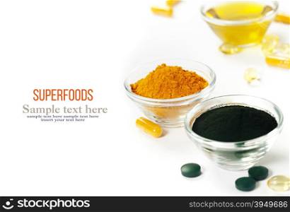 Alternative natural medicine. Dietary supplements. Spirulina, turmeric and organic oil on white background. Superfood, detox or diet concept