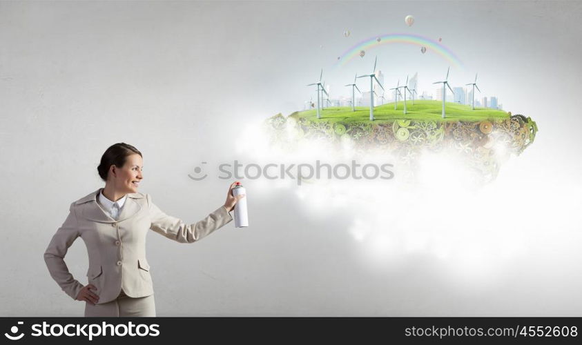 Alternitive energy concept. Young businesswoman spraying eco concept from aerosol balloon