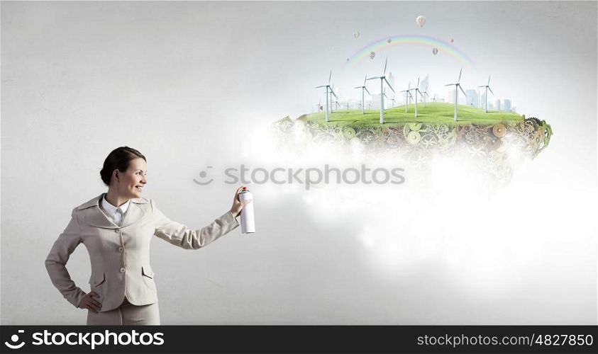 Alternitive energy concept. Young businesswoman spraying eco concept from aerosol balloon