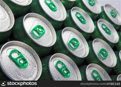 Aluminum cans in drops of water with keys close-up