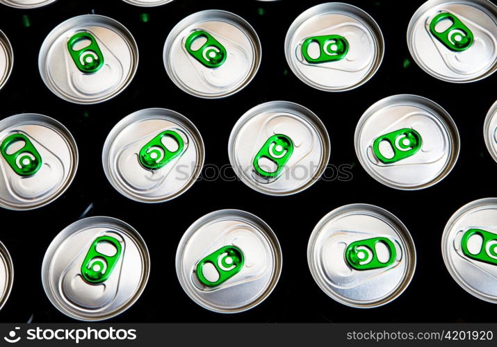 Aluminum cans in drops of water with keys close-up, focus on center