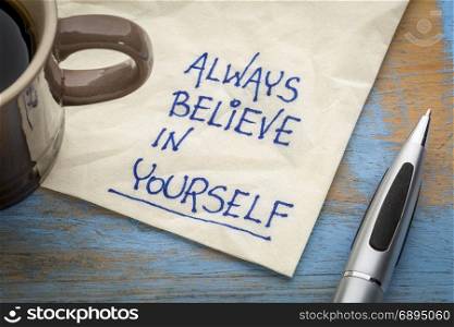 Always believe in yourself - handwriting on an napkin with a cup of coffee