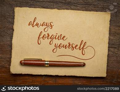 always forgive yourself inspirational advice or reminder - handwirting on a handmade paper, positive mindset and personal development concept