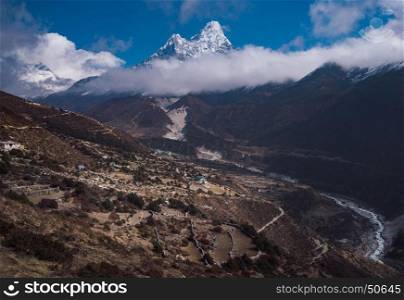 Ama Dablam and Nepalese village in Himalayas. Travel trekking and tourism in Nepal