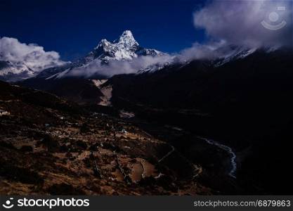 Ama Dablam summit or peak and Nepalese village in Himalayas. Travel trekking and tourism in Nepal