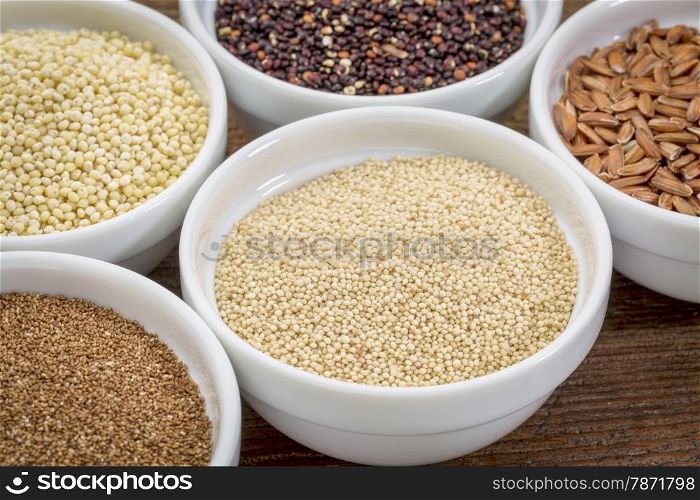amaranth and other gluten free grains (teff, millet, quinoa, brown rice) in small ceramic bowls