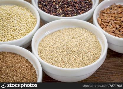 amaranth and other gluten free grains (teff, millet, quinoa, brown rice) in small ceramic bowls
