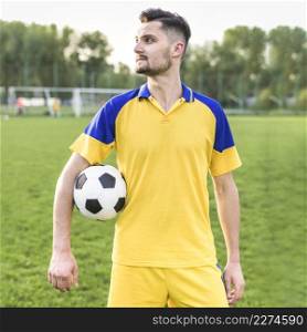 amateur football concept with man posing with ball