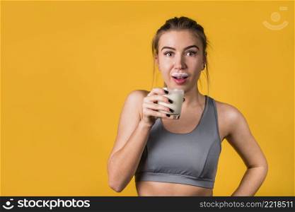 amazed attractive young woman sportswear with glass milk