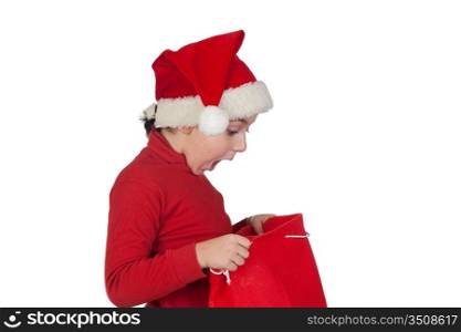 Amazed boy looking in the Christmas bag isolated on white background