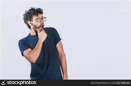 Amazed person with open mouth looking to the side, astonished handsome man looking at an advertisement. astonished people looking at a banner to the right