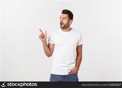 Amazed smart man pointing up at copy space over white background. Amazed smart man pointing up at copy space over white background.