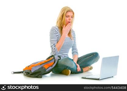 Amazed teen girl sitting on floor with backpack and looking on laptop isolated on white &#xA;